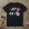 Black t-shirt with white text "I AM 44+" and a graphic of sparkly pink lips with a finger shushing gesture