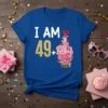I AM 49+ birthday t-shirt with gold glitter number 49 and a bouquet of pink flowers