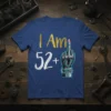 I Am 52+ text with robot middle finger graphic on a navy blue t-shirt for a birthday celebration