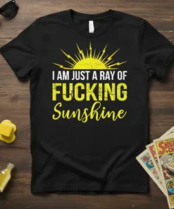 Black t-shirt with "I AM JUST A RAY OF FUCKING Sunshine" in bold yellow and white distressed typography, featuring a