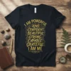 Dark t-shirt with gold text "I AM POWERFUL KIND, CONFIDENT BEAUTIFUL STRONG CAPABLE GRATEFUL I AM ME" in decorative font