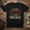 I Am Not Old I Am Vintage quote on a black t-shirt, featuring distressed text and retro decorative elements