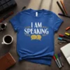 Blue t-shirt with white and gold text "I AM SPEAKING" and gold speech bubble graphics