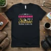 I Am A Grandma And A Nurse Nothing Scares Me quote t-shirt with pink and gold text and a nurse's