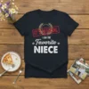 Dark t-shirt with white text that says "IT'S OFFICIAL I AM THE Favorite NIECE" and laurel wreath graphic