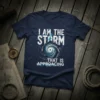 T-shirt with "I AM THE STORM THAT IS APPROACING" text and a swirling hurricane graphic in white and blue