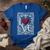 I BELIEVE IN LOVE text with a geometric heart graphic on a blue t-shirt, ornate white and gold border