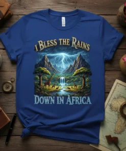 I Bless The Rains Down In Africa quote on a blue t-shirt featuring a dramatic lightning storm over mountains, giraffes