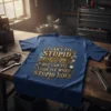 Steampunk-inspired graphic t-shirt with the quote "I Can't Fix Stupid But Can Fix What Stupid Does" in gold lettering