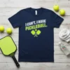 Navy t-shirt with white and lime green text "I CAN'T. I HAVE PICKLEBALL." and graphic of pickleball paddles and ball