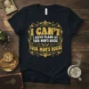 Black t-shirt with gold vintage-style text: "I CAN'T I HAVE PLANS AT YOUR MOM'S HOUSE YOUR MOM'S HOUSE" quote design