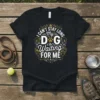 I Can't Stay Long My Dog is Waiting For Me text design with a paw print graphic on a black