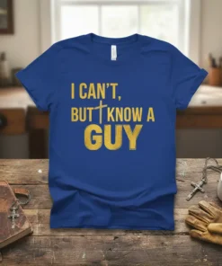 Blue t-shirt with "I CAN'T, BUT KNOW A GUY" in gold distressed font, featuring a cross symbol