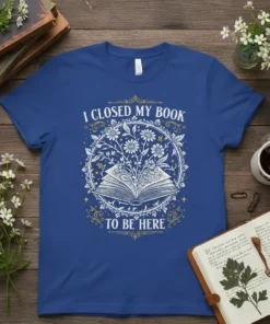 I Closed My Book To Be Here quote on a royal blue t-shirt with a circular floral design around an