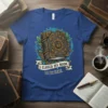 I CLOSED MY BOOK TO BE HERE quote on a blue t-shirt with a detailed ancient book graphic and magical