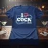 Blue t-shirt with white neon-style text "I COCK Tails" and a red heart above "COCK"