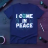 Blue t-shirt with white text "I COME IN PEACE" and a turquoise peace symbol, surrounded by a blue circuit board