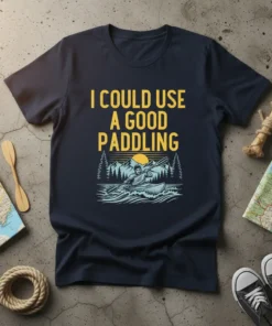 Navy t-shirt with yellow text "I COULD USE A GOOD PADDLING" above a graphic of a kayaker on water with