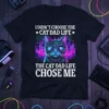 I Didn't Choose The Cat Dad Life text with a cool cat wearing sunglasses and a cityscape background, on a