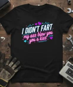T-shirt with the bold text "I DIDN'T FART my ass blew you a kiss" in neon pink and blue font
