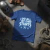 Blue t-shirt with white distressed text "I DO ALL MY OWN STUNTS" and three blue stars below