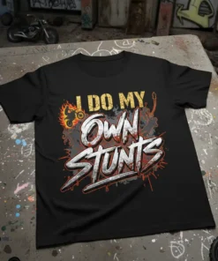 Black t-shirt with yellow and white text "I DO MY OWN STUNTS" and a flaming motocross rider graphic