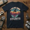 I Do My Own Stunts T-Shirt with a silhouette of a skateboarder using crutches on a ramp, set against a