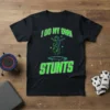 Black t-shirt with neon green text "I Do My Own Stunts" and a graphic of a person jumping on a