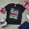 I Do Pilates Because Punching Is Frowned Upon quote on a black t-shirt, with pink and white distressed typography