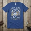 Cowgirl with hat and horses graphic with text "I Do A Thing Called What I Want" on a blue t-shirt
