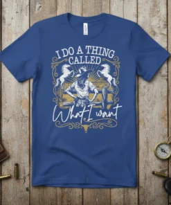 Cowgirl with hat and horses graphic with text "I Do A Thing Called What I Want" on a blue t-shirt