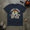 I Don't Crash I Stop With Style text with a cyclist silhouette in a sunset graphic on a navy t-shirt