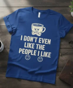 I DON'T EVEN LIKE THE PEOPLE I LIKE funny coffee quote on a blue t-shirt with a grumpy coffee cup