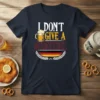 I DON'T GIVE A SCHNITZEL text with beer mug and German flag graphic on a navy t-shirt