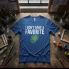 Blue t-shirt with white text "I DON'T HAVE A FAVORITE" and colorful abstract scribbles below