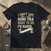 T-shirt with the quote "I DON'T LIKE BEING TOLD WHAT TO DO I'M NAKED" in bold typography, featuring handcuffs graphic