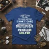 Blue t-shirt with white and green text reading "I DON'T LIVE My Life TO PLEASE ANYONE I DON'T CARE what