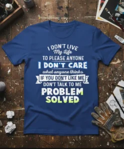 Blue t-shirt with white and green text reading "I DON'T LIVE My Life TO PLEASE ANYONE I DON'T CARE what