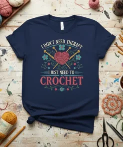 I Don't Need Therapy I Just Need To Crochet text with heart-shaped yarn ball and needles graphic on navy t-shirt