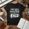 Black t-shirt with white text "I DON'T NEED A mood Ring I HAVE A FACE" and colorful paint splatters