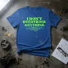 I DON'T OVERTHINK ANYTHING quote on a blue t-shirt with green circuitry design and a gear graphic