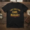 T-shirt with yellow text "I DON'T REALLY CARE, CARE, MARGARET" in a distressed, vintage font, designed for humor