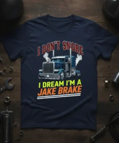 I Don't Snore I Dream I'm A Jake Brake graphic t-shirt featuring a semi-truck and bold text