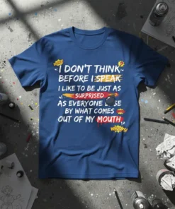Blue t-shirt with white and yellow text: "I DON'T THINK BEFORE I SPEAK I LIKE TO BE JUST AS SURPRISED