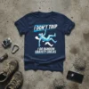 Navy t-shirt with white and blue text "I DON'T TRIP I DO RANDOM GRAVITY CHECKS" and a geometric climber graphic