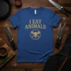 Blue t-shirt with distressed gold text "I EAT ANIMALS" and a circular graphic of a bull skull with crossed cleavers