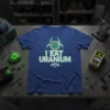 I Eat Uranium T-Shirt featuring a biohazard symbol with atomic structure and glitch text, dark blue tee