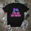 Black t-shirt with "I Feel Like 2007 Britney" in neon pink text and a glitchy purple icon graphic