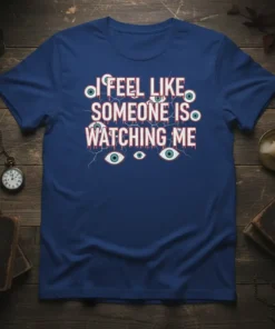 I Feel Like Someone Is Watching Me quote on a dark blue t-shirt with creepy eye graphics