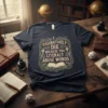 T-shirt with the quote "I Figuratively Die Because You Literally Abuse Words" in ornate lettering above an open book graphic